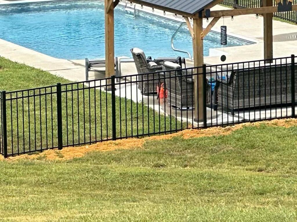 A black aluminum fence installed around a swimming pool for safety by Frontier Fence LLC Bowling Green,Ky