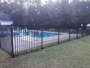 A black aluminum fence installed around a swimming pool by Rowe Fence & Supply in New Kent, VA.