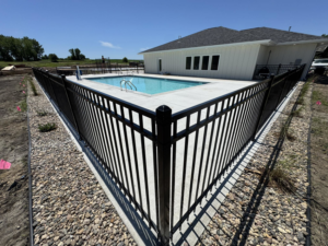 Newly installed black aluminum fence enclosing a swimming pool by Solid Fence Co. in Sioux Falls, SD.