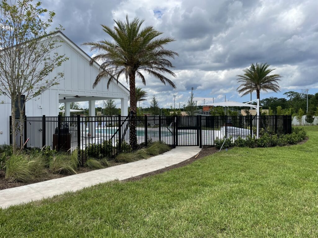 A black aluminum fence surrounding a community pool area, installed by Masters Fence Contracting in Jacksonville, FL.