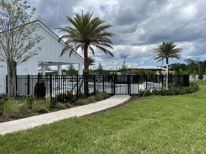 A black aluminum fence surrounding a community pool area, installed by Masters Fence Contracting in Jacksonville, FL.