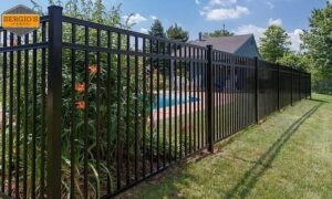 A newly installed black aluminum fence enclosing a pool area by Sergio's Fence in Kansas City, KS.