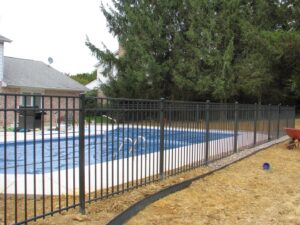 A black aluminum fence installed around a swimming pool by Snyders Custom Fencing in York, PA.