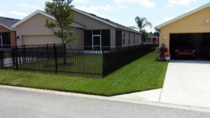 A black aluminum fence installed around a residential property by Goldstar Fencing in Mascotte, FL.