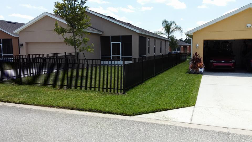 A black aluminum fence installed around a residential property by Goldstar Fencing in Mascotte, FL.
