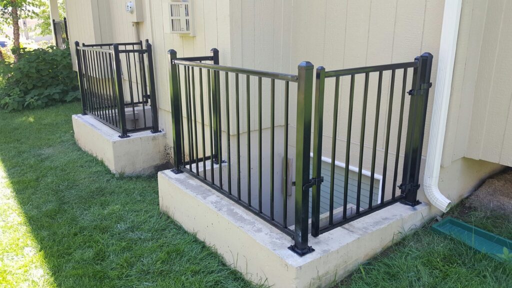 A black aluminum fence installed around a residential property by Royal Fence & Design LLC in Olathe, KS.