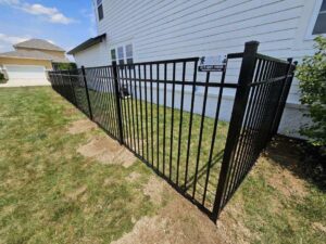 A black aluminum fence installed along the side of a house by Hoplite Services in Indianapolis, IN.