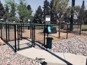 A black chain link fence enclosure for a dog park installed by No Limit Fence Company in Huntington Beach, CA.