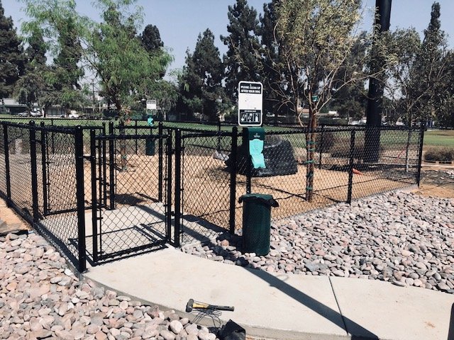 A black chain link fence enclosure for a dog park installed by No Limit Fence Company in Huntington Beach, CA.