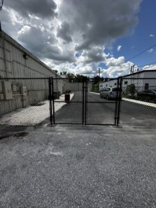 A black chain-link double gate installed by Elite Fence and Outdoor of Tampa Bay in Tampa, FL.