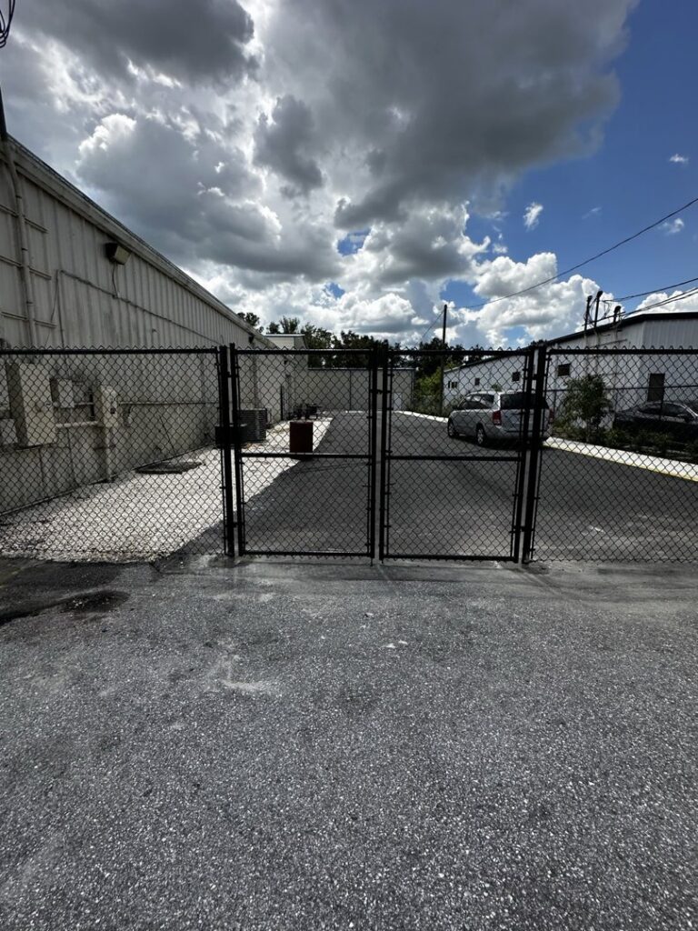A black chain-link double gate installed by Elite Fence and Outdoor of Tampa Bay in Tampa, FL.
