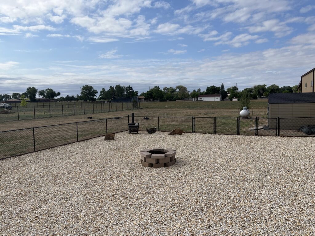A black chain-link fence enclosing a backyard area, installed by Fence Tech in Everett, WA.