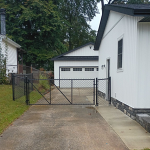 A black chain-link fence and gate installed along a residential driveway by Meyers Fence Company in Kent, OH