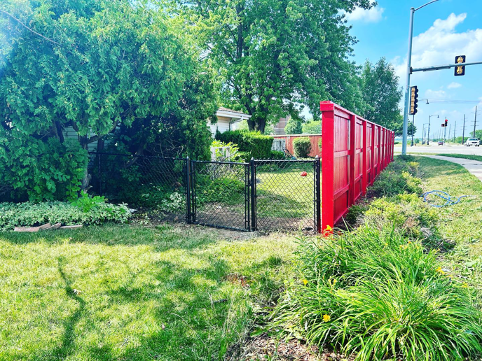 A newly installed black chain-link fence and gate by HammerHorn Fence & Gate Systems in Rochelle, IL.