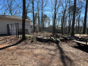 A black chain-link fence line installed around a residential property by Allen Fences & Decks, LLC in Tuscaloosa, AL.