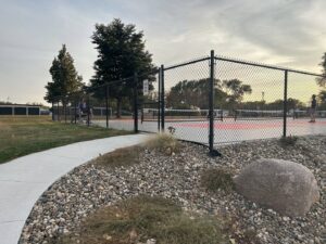 A black chain link fence installed around a pickleball court by Bostwick Fencing, LLC in Sioux City, IA.