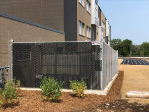 A black chain-link fence with privacy slats installed by Northway Fence in Menomonee Falls, WI.