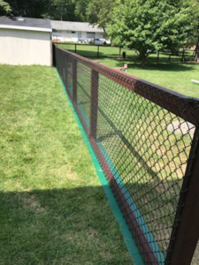 Durable black chain-link fence with a sturdy brown frame installed by Wildfire Products Inc. in West Fargo, ND