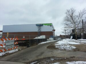 A newly installed black chain-link fence with a gate by Pro-Soil Site Services, Inc in Lansing, MI