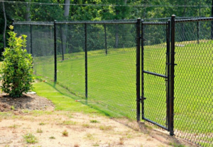 A black chain-link fence with a matching gate installed by Sumter Fence Company in South Sumter, SC.