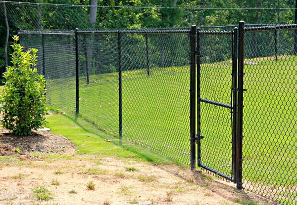 A black chain-link fence with a matching gate installed by Sumter Fence Company in South Sumter, SC.