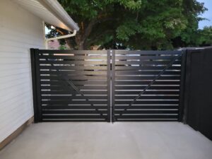 A sleek black horizontal slat driveway gate installed by Allied Fence Co in Tulsa, OK.