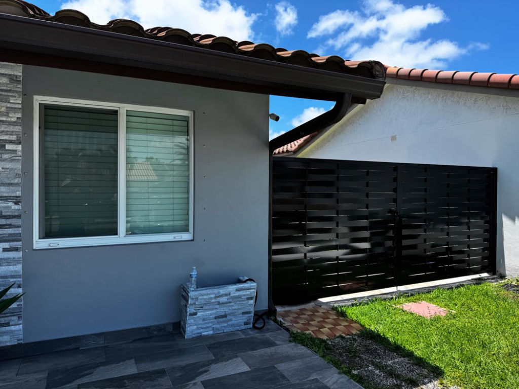 A black horizontal slat privacy fence installed between residential properties by HD Multi Service USA INC in Miami, FL.