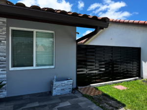 A black horizontal slat privacy fence installed between residential properties by HD Multi Service USA INC in Miami, FL.