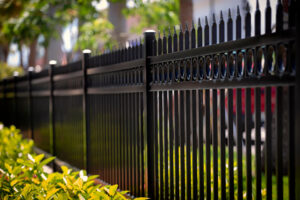 A black iron perimeter fence with decorative elements installed by Ironcraft Welding in Chicago, IL.