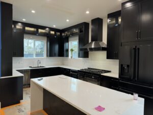 Stylish black kitchen with recessed and under-cabinet lighting installed by Silverline Electric LLC in Kennewick, WA.
