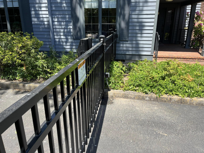 A black metal automatic gate installed by Prestige Fencing LLC in Medford, OR.
