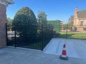 A newly installed black metal fence enclosing a property, demonstrating quality work by Fence Fair in Baltimore, MD.