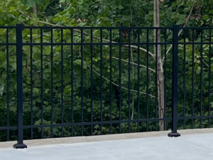 A sleek black metal fence installed by First Class Fence and Landscape LLC in Birmingham, AL, possibly for a pool or patio.