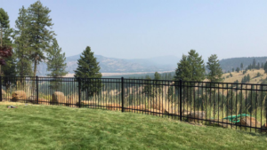 A newly installed black metal fence overlooking a scenic valley by The Best Fence Company in Spokane, WA.