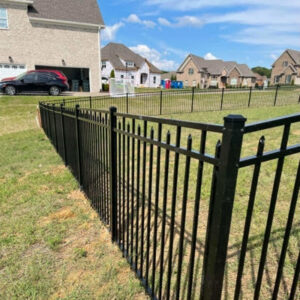 A durable black metal fence installed around a residential property by Stand Strong Fencing of East Austin, TX.