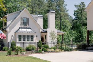 A black metal fence and gate complementing a white house by Heron Building Co in Franklin, TN.