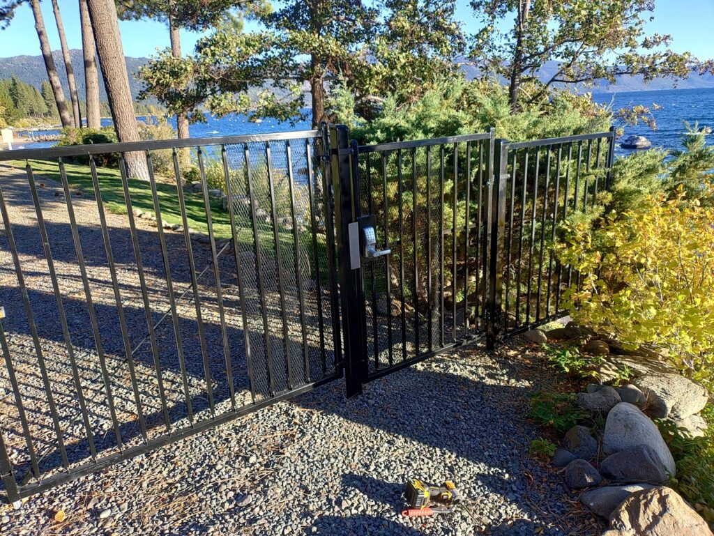 A secure black metal gate with a modern keypad lock installed by Finest Fence in Simi Valley, CA.