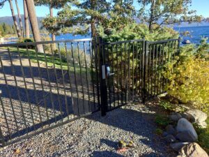 A secure black metal gate with a modern keypad lock installed by Finest Fence in Simi Valley, CA.