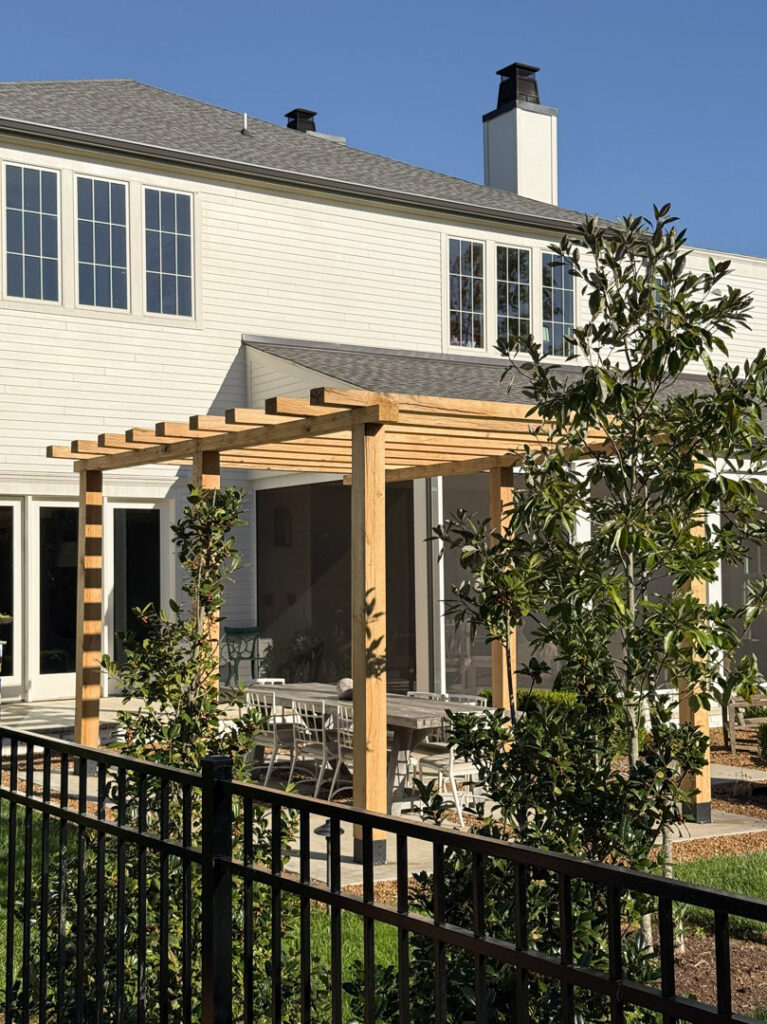 A black metal fence enclosing a modern patio area by Heron Building Co in Franklin, TN.