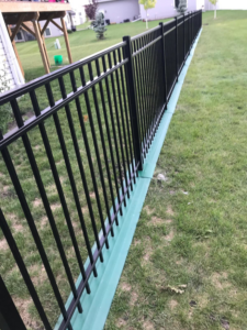 Elegant black metal picket fence installed for a residential property by Wildfire Products Inc. in West Fargo, ND