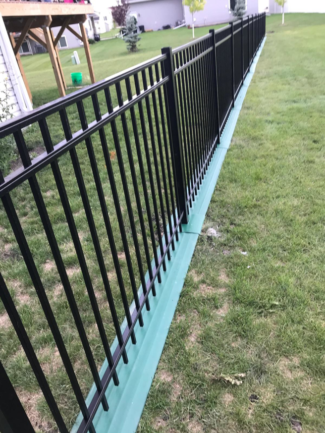 Elegant black metal picket fence installed for a residential property by Wildfire Products Inc. in West Fargo, ND