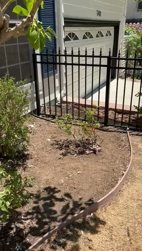 A black metal picket fence installed in front of a residential property by Coastline Gate Repair in Los Angeles, CA.
