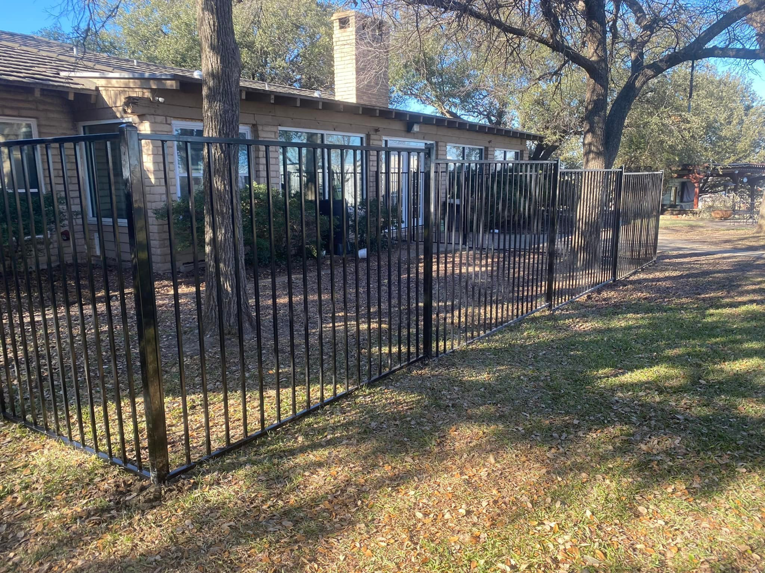 Black metal picket fence installed around a residential property by Plano Fence and Arbor Pro in Plano, TX.