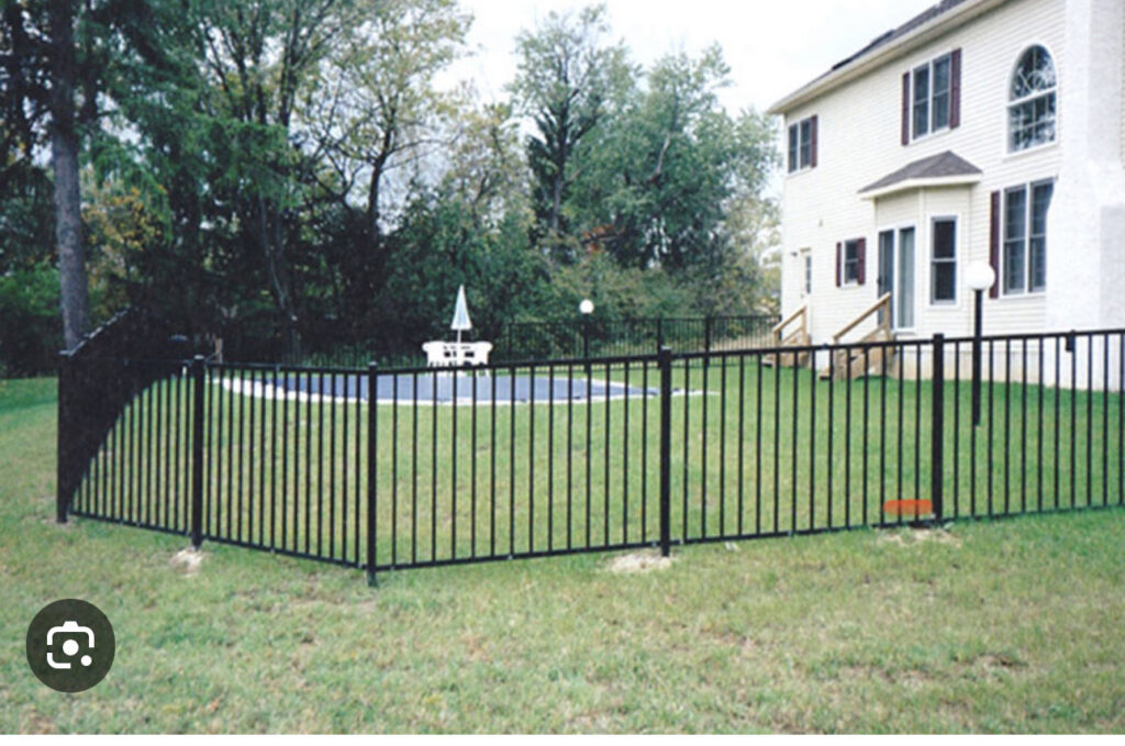 A black metal fence installed around a swimming pool by Liberty Fence & Stain in San Antonio, TX.