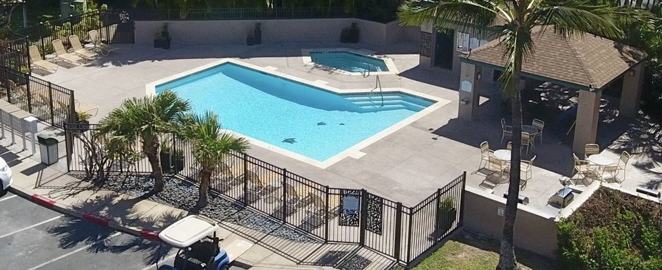 A black metal fence enclosing a swimming pool area installed by Redmond Valleywide - Hawaii's Fence Company in Kapolei, HI