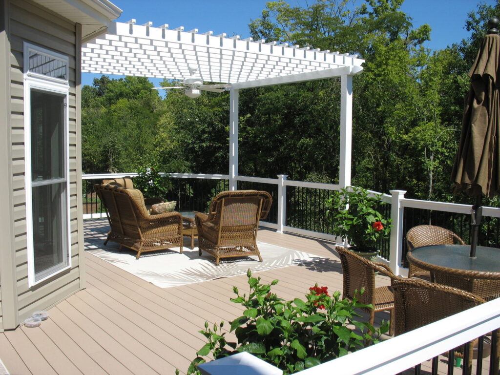 A black metal fence providing safety around a residential swimming pool, installed by Custom Design Fence & Deck, Inc. in Ofallon, MO