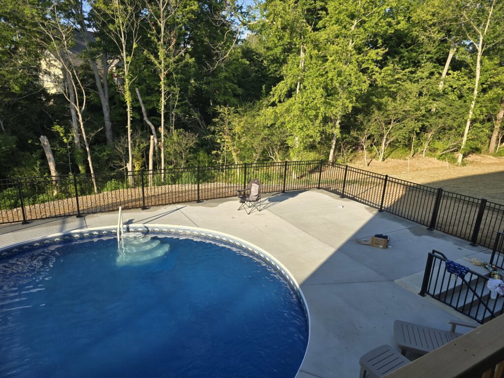 A black metal fence installed around a swimming pool by Superior Fence & Rail of Northern Kentucky in Florence, KY.