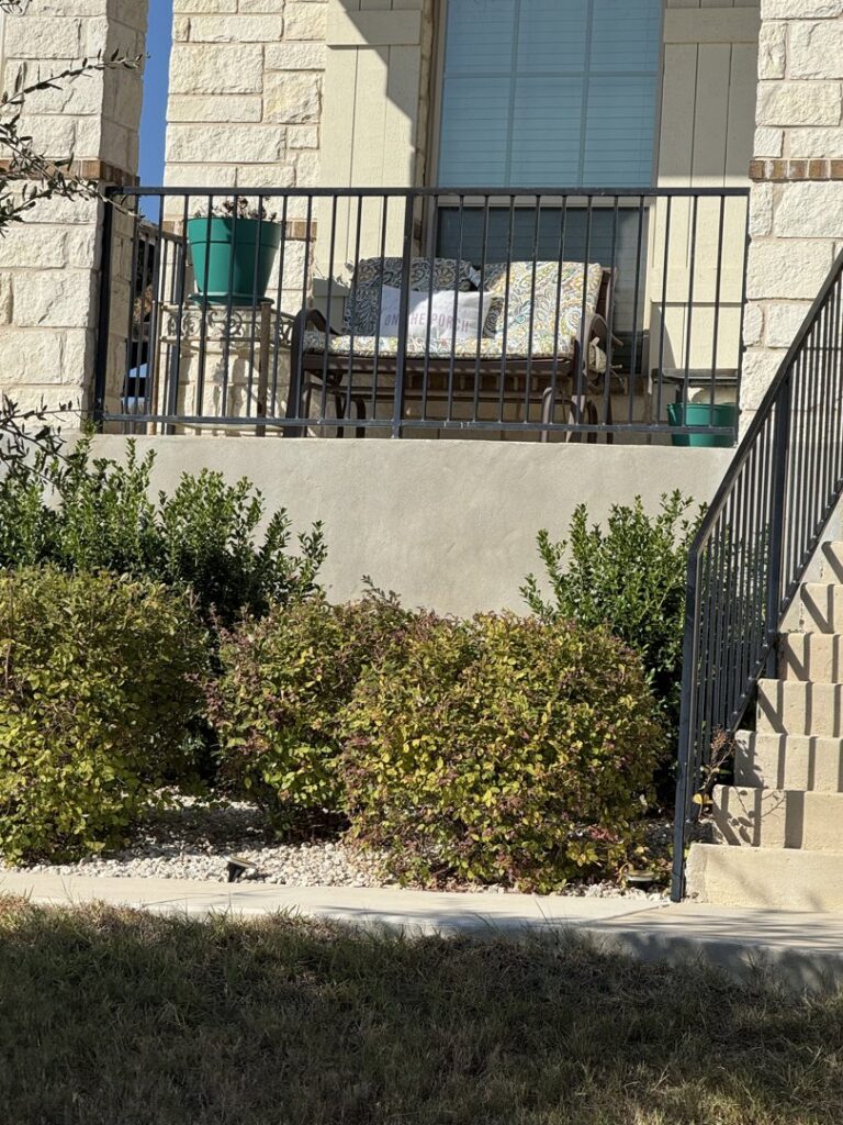 A black metal railing installed on a residential porch by Liberty Fence & Stain in San Antonio, TX.