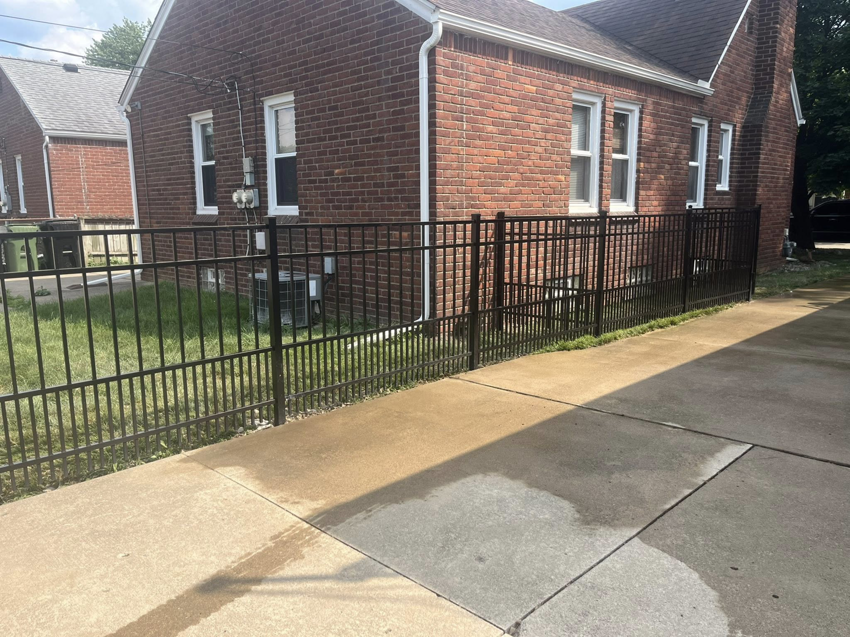 A newly installed black metal fence around a residential property by Final Touch Fencing LLC in Macomb Township, MI.