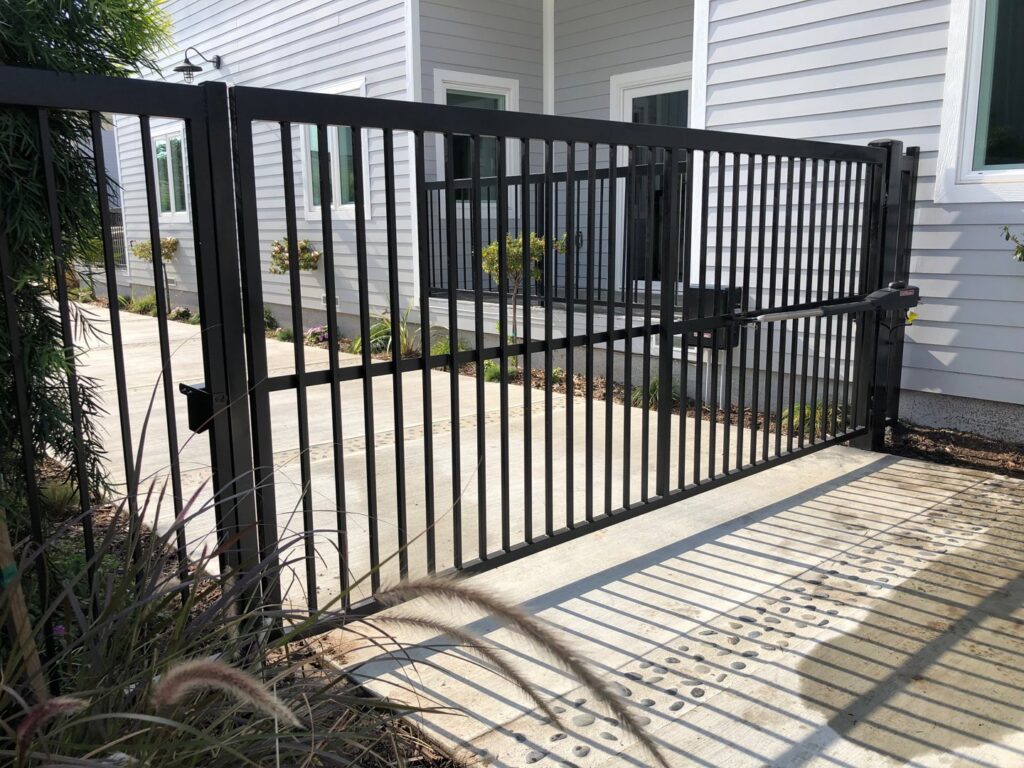 A black metal security fence with a matching gate installed by Los Angeles Fence Builders in Los Angeles, CA.